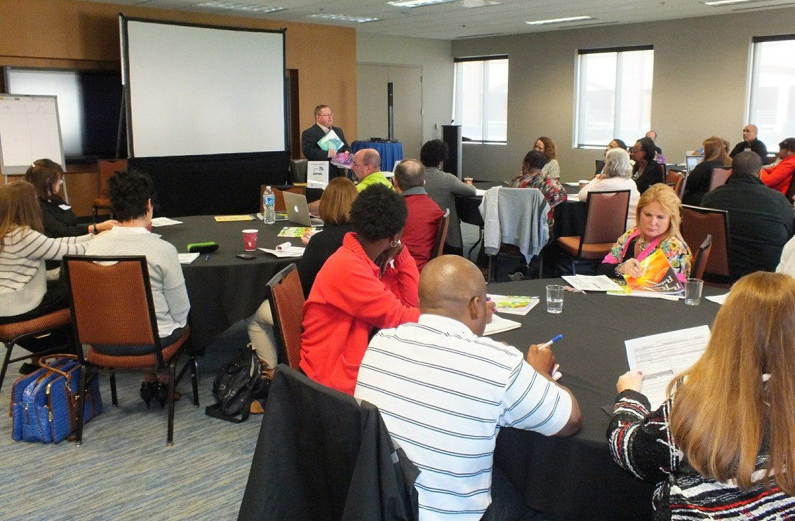 Eric Combs presenting to a conference room of educators
